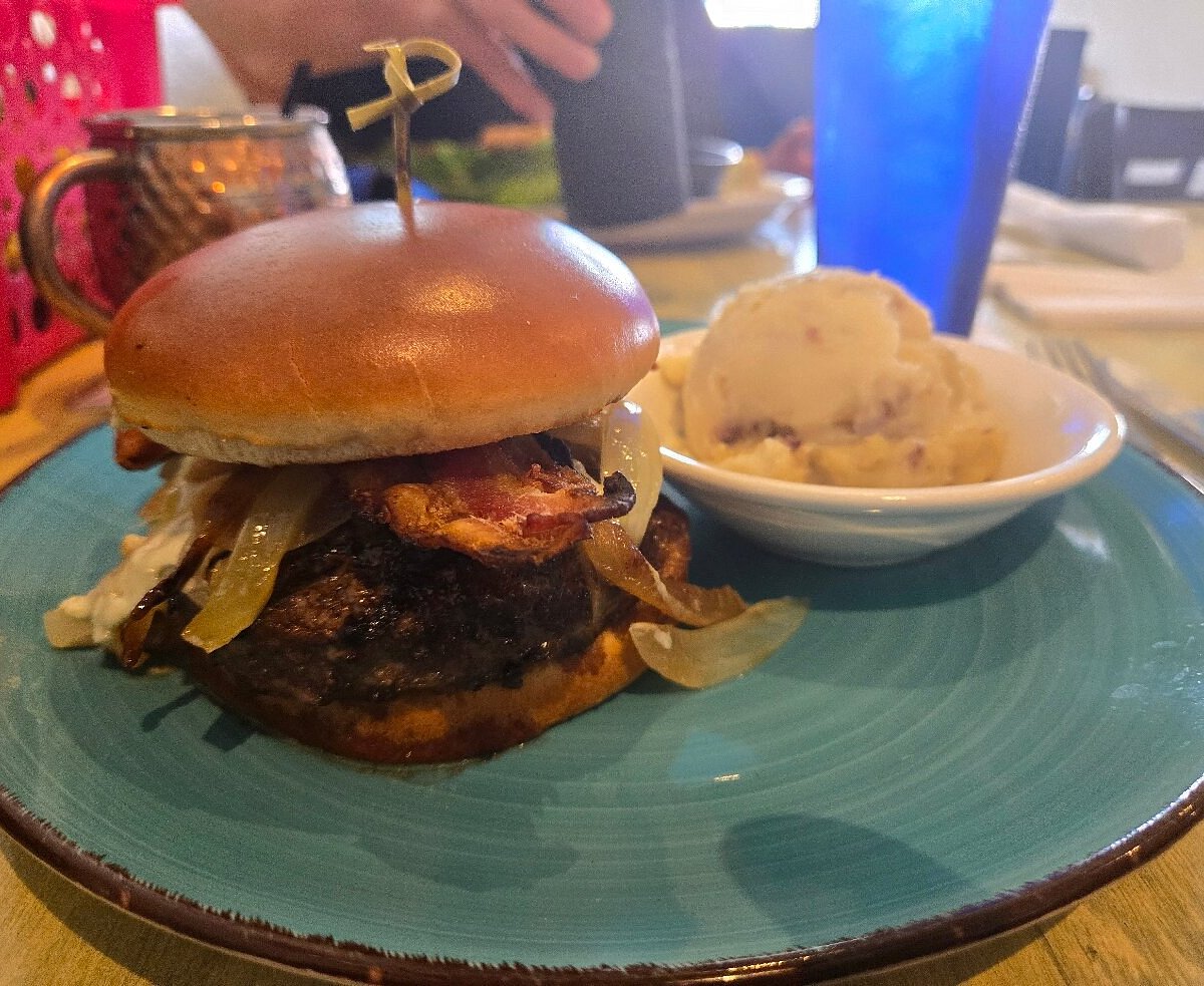 FINS Seafood & Dive Bar signature dishes Peel N' Eat Shrimp Half Pound, Bimini Wrap, Black & Bleu Burger.